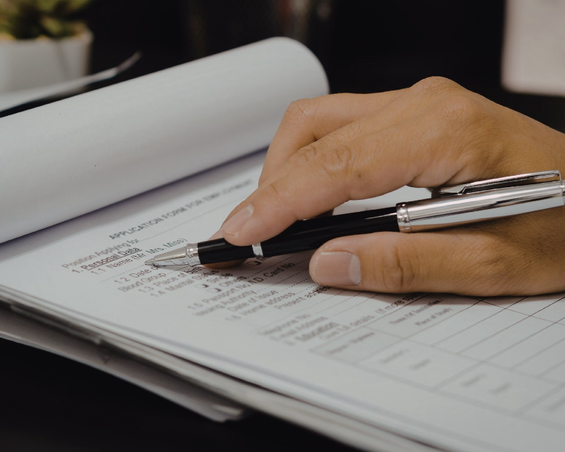 Business owner completing an intake form with a pen during the first step of a Financial Diagnostic Review