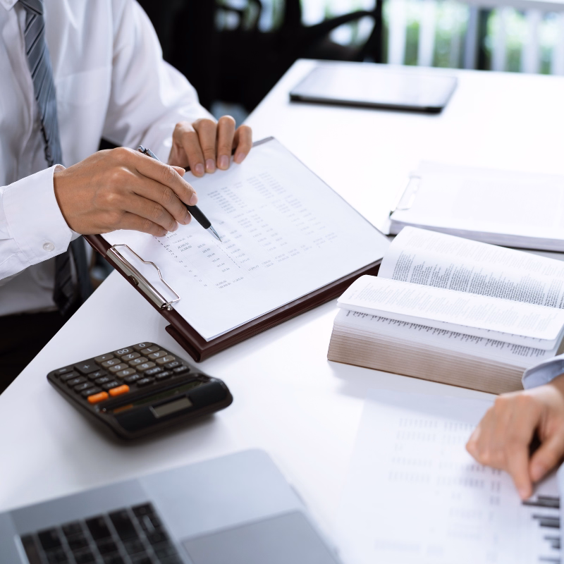 Financial reporting concept image showing organized reports, charts, and bookkeeping tools on a clean professional desk