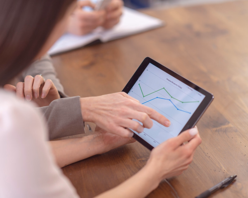 Ongoing bookkeeping support workspace with a desktop monitor, workflow checklist, keyboard, and organized paperwork on a professional desk