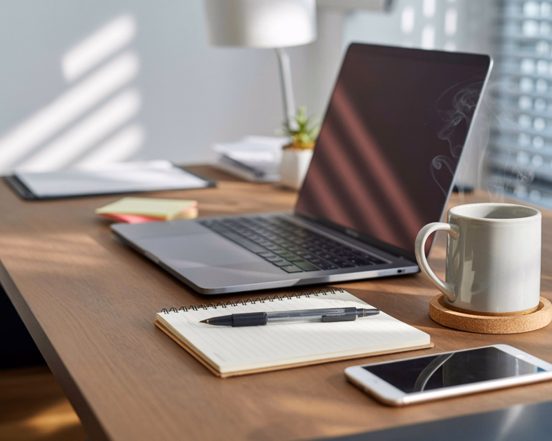 QuickBooks Online support concept image showing a stable bookkeeping workspace with organized documents, a desktop monitor, and workflow tools on a clean desk