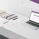 Organized bookkeeping workspace with laptop, financial reports, and calendar for a service business